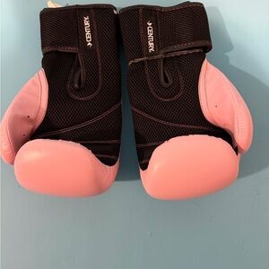 Venum Black and Pink Boxing Gloves
By Century